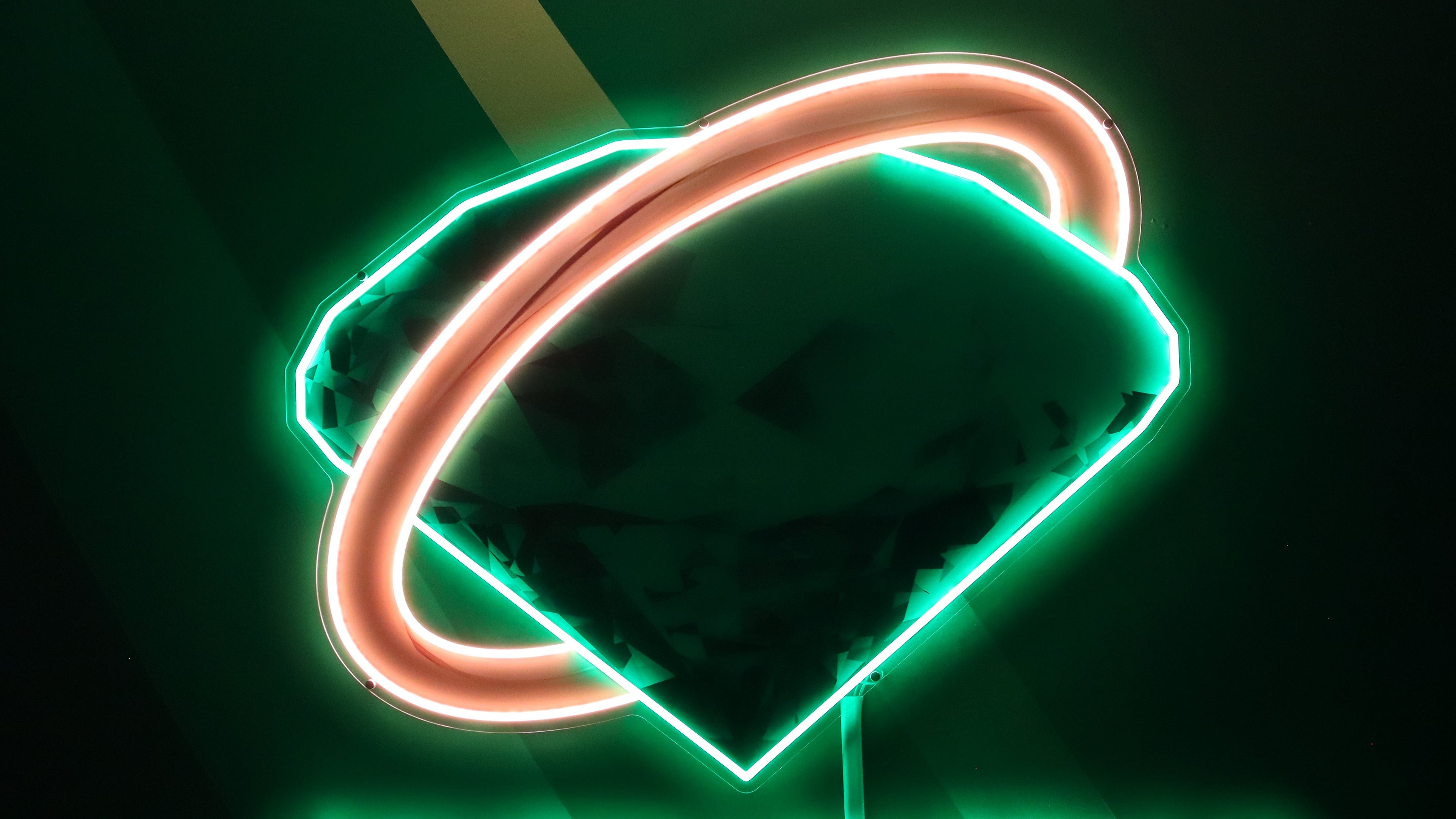Neon sign with 'Fourth Emerald Games' logo on a dark background